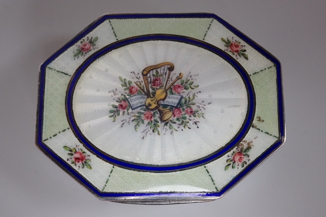 An Edwardian silver and guilloche enamel octagonal box with hinged cover, import marks for Erich Kellerman, London, 1909, decorated with flowers and musical instruments, 77mm.